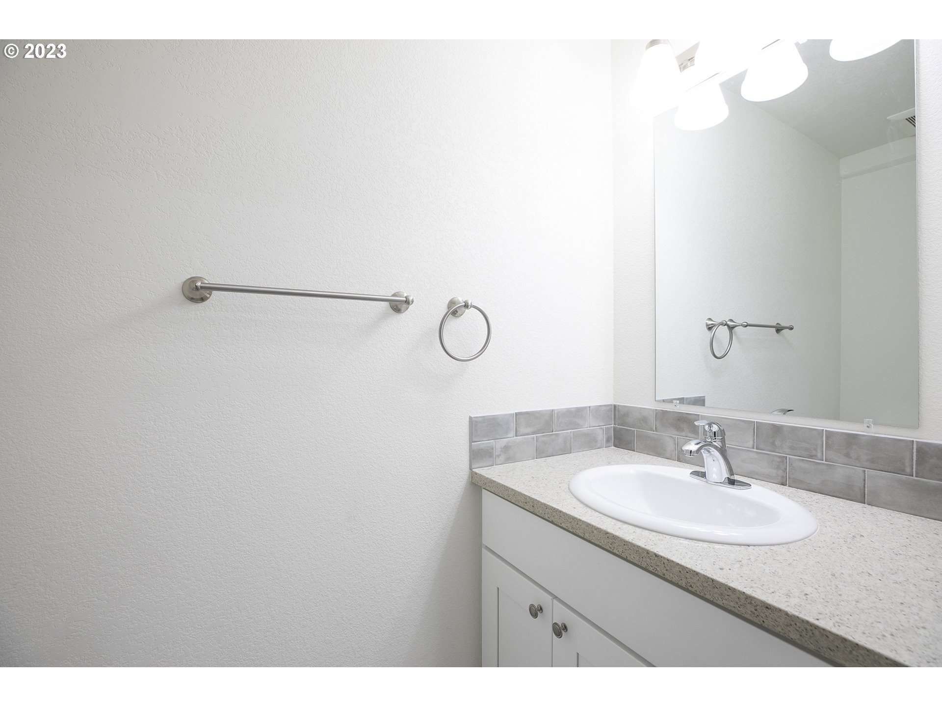 9046 Southeast Clinton Street, Unit B Portland, OR 97266 - Photo 10 of 18 a bathroom with a sink and a mirror