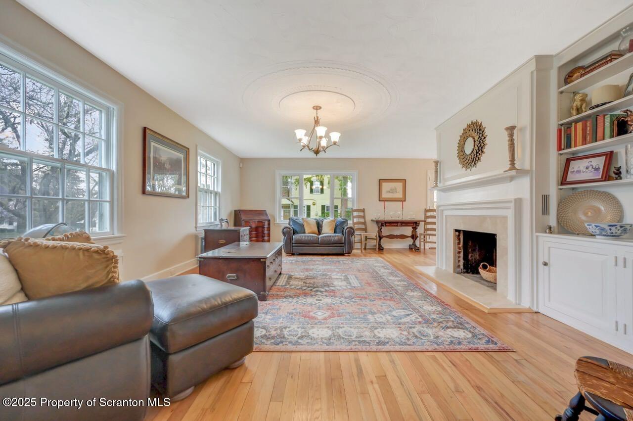 235 North Abington Road Clarks Green, PA 18411 - Photo 18 of 79 a living room with furniture a fireplace and a window