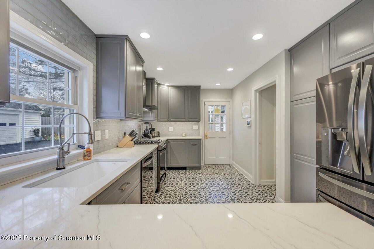 235 North Abington Road Clarks Green, PA 18411 - Photo 25 of 79 a kitchen with stainless steel appliances granite countertop a sink refrigerator and cabinets