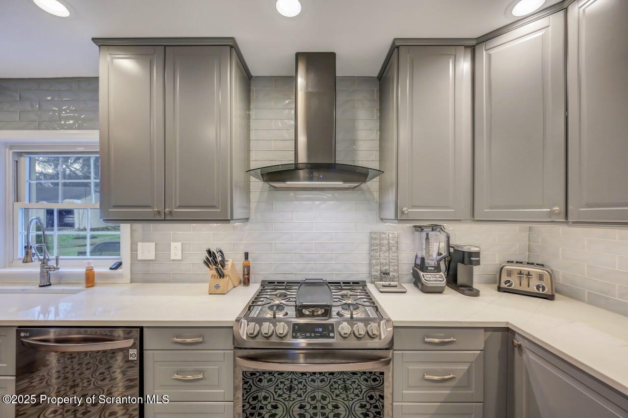 235 North Abington Road Clarks Green, PA 18411 - Photo 32 of 79 a kitchen with stainless steel appliances granite countertop a stove a refrigerator and a white cabinets