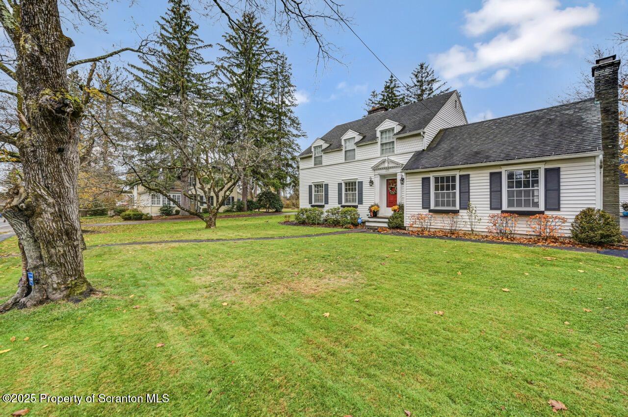 235 North Abington Road Clarks Green, PA 18411 - Photo 4 of 79 a front view of a house with a garden and trees