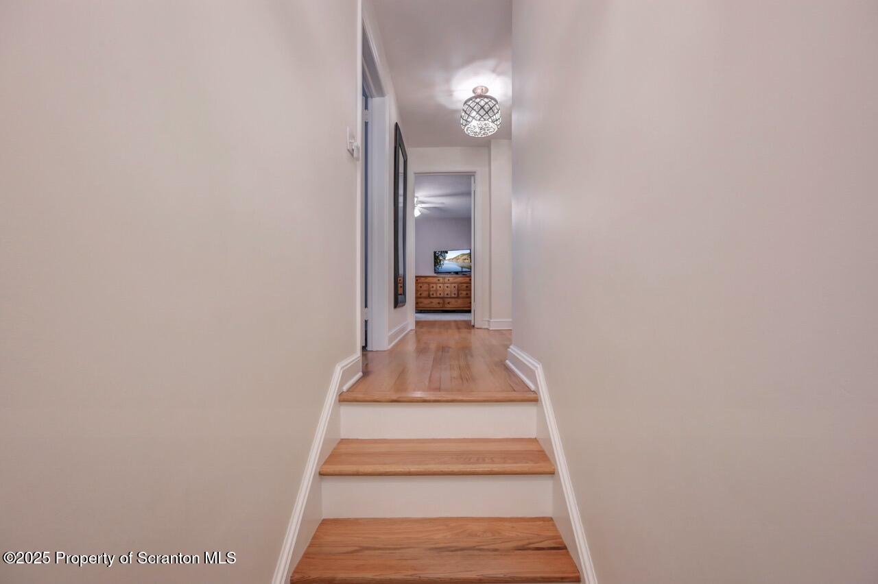 235 North Abington Road Clarks Green, PA 18411 - Photo 49 of 79 a view of a hallway with wooden floor and a bathroom