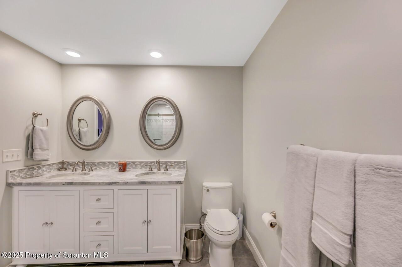 235 North Abington Road Clarks Green, PA 18411 - Photo 58 of 79 a bathroom with a toilet a sink and a mirror