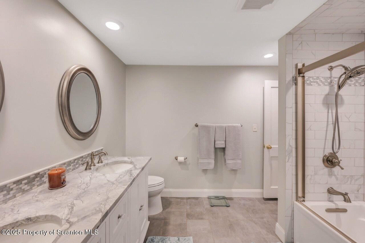 235 North Abington Road Clarks Green, PA 18411 - Photo 59 of 79 a bathroom with a granite countertop sink a toilet and shower