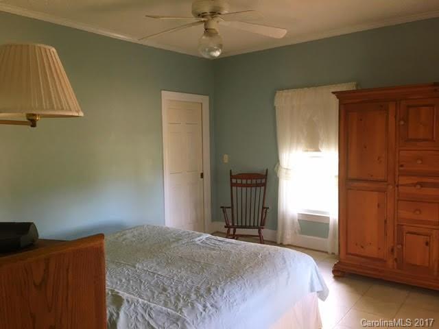 7503 Potter Road Waxhaw, NC 28173 - Photo 14 of 18 a bedroom with a bed and wooden floor