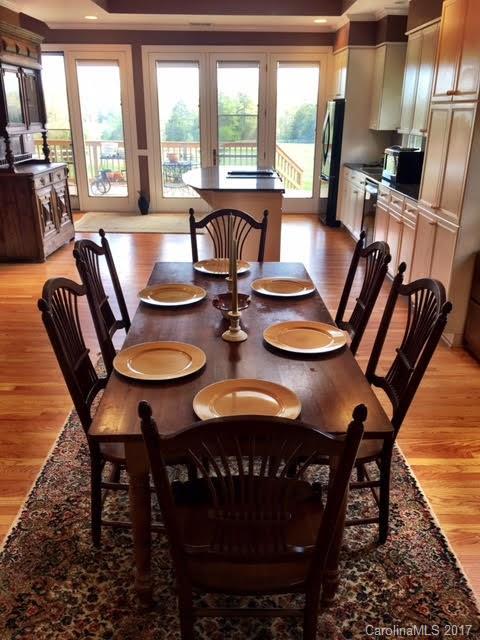 7503 Potter Road Waxhaw, NC 28173 - Photo 5 of 18 a view of a dining room with furniture large windows and wooden floor