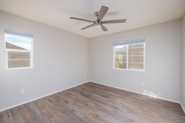 a view of a big room with wooden floor closet and windows