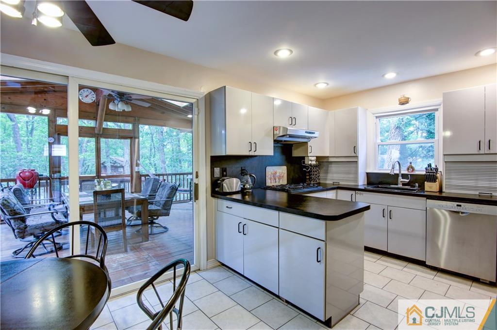 24 Donald Road East Brunswick, NJ 08816 - Photo 11 of 20 a kitchen with stainless steel appliances granite countertop a sink a stove and a refrigerator