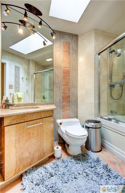 24 Donald Road East Brunswick, NJ 08816 - Photo 16 of 20 a bathroom with a double vanity sink toilet and shower