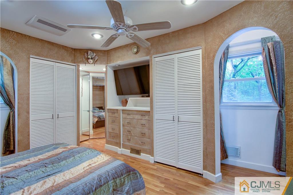 24 Donald Road East Brunswick, NJ 08816 - Photo 17 of 20 a bedroom with a bed and a flat screen tv