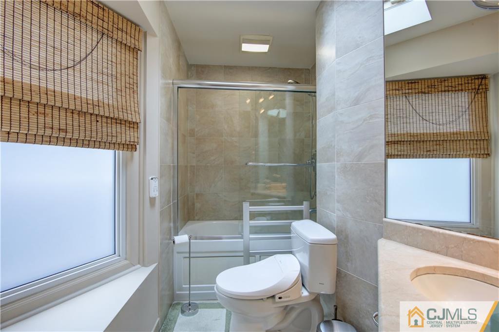 24 Donald Road East Brunswick, NJ 08816 - Photo 18 of 20 a bathroom with a toilet a window and shower