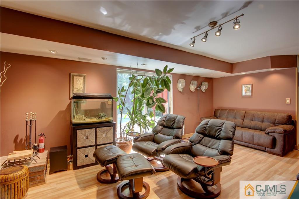 24 Donald Road East Brunswick, NJ 08816 - Photo 8 of 20 a living room with furniture gym equipment and a large window