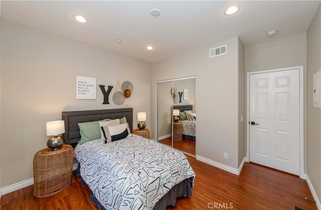 372 Quail Irvine, CA 92603 - Photo 12 of 22 a bedroom with a bed and wooden floor
