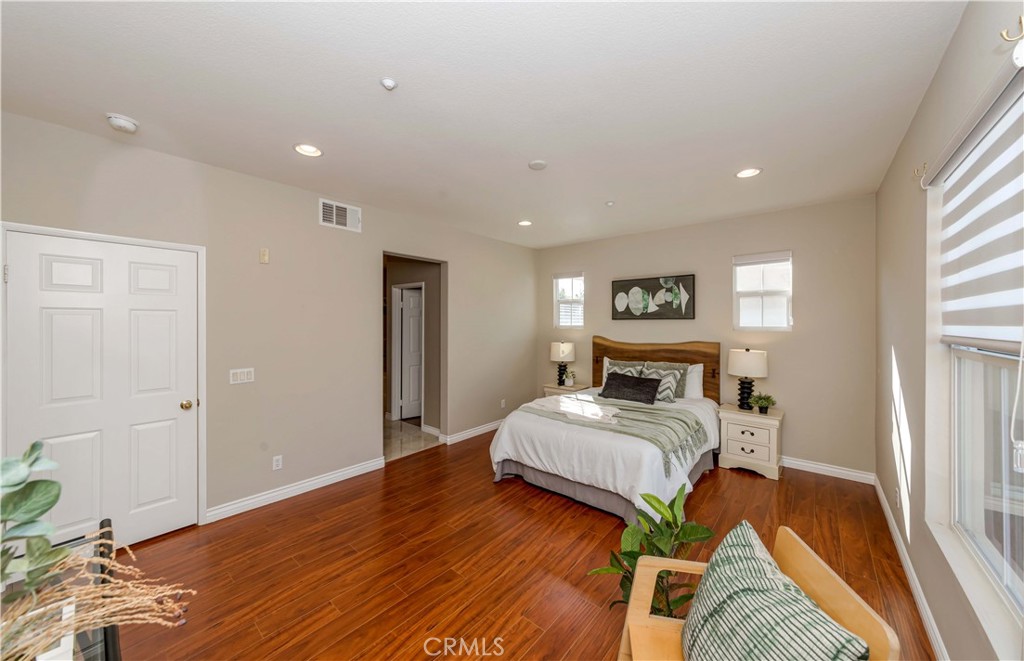 372 Quail Irvine, CA 92603 - Photo 15 of 22 a bedroom with a bed and wooden floor