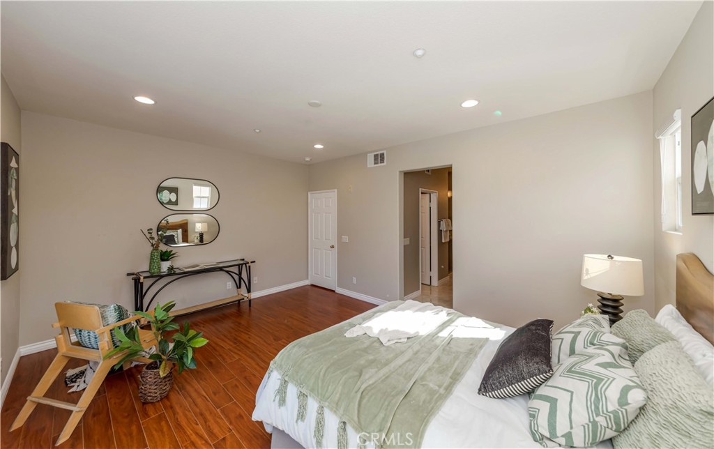 372 Quail Irvine, CA 92603 - Photo 16 of 22 a bedroom with a bed and wooden floor
