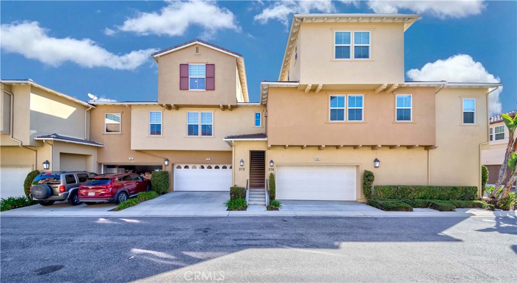 372 Quail Irvine, CA 92603 - Photo 2 of 22 a front view of a house with parking space and a car parked in front of it