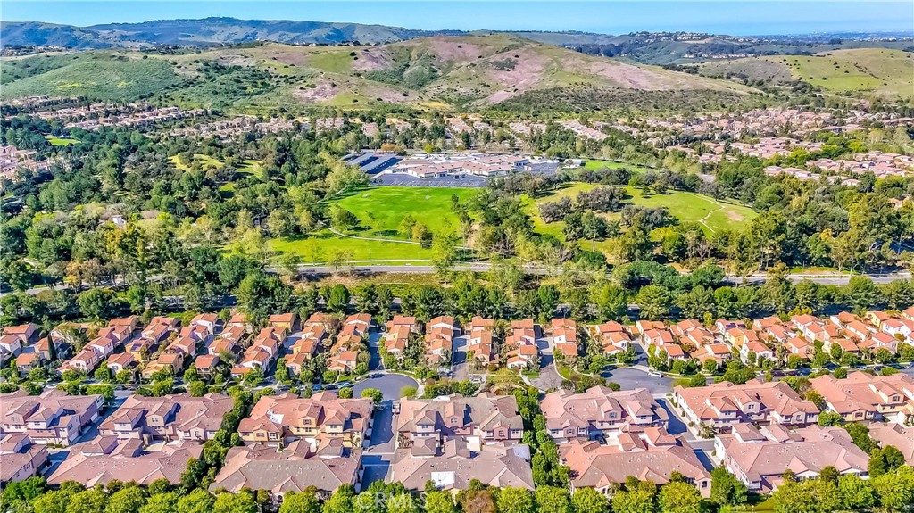 372 Quail Irvine, CA 92603 - Photo 22 of 22 an aerial view of a city with lots of residential buildings and mountain view in back