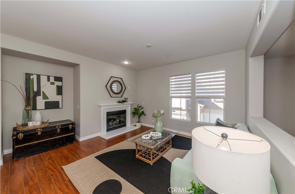 372 Quail Irvine, CA 92603 - Photo 3 of 22 a living room with furniture a window and a fireplace