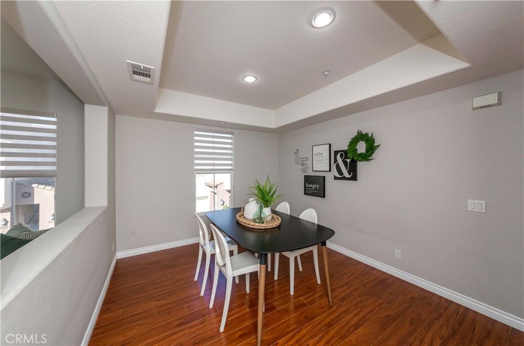 372 Quail Irvine, CA 92603 - Photo 8 of 22 a view of a dining room with furniture and wooden floor