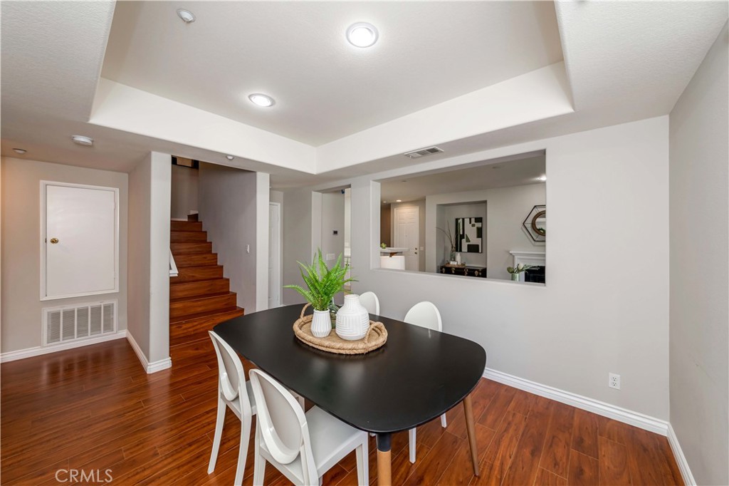 372 Quail Irvine, CA 92603 - Photo 9 of 22 a view of a dining room with furniture and wooden floor