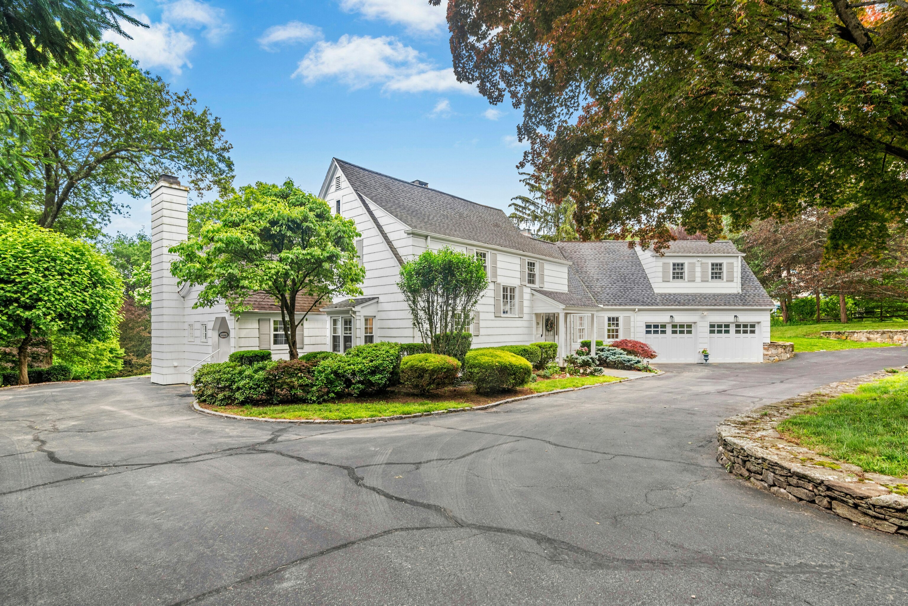 a view of a house with a yard and potted plants