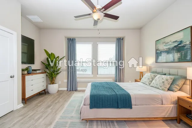 a bedroom with a large bed and a potted plant