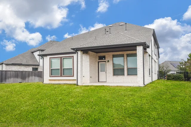 a front view of house with a garden