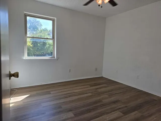 wooden floor in an empty room with a window
