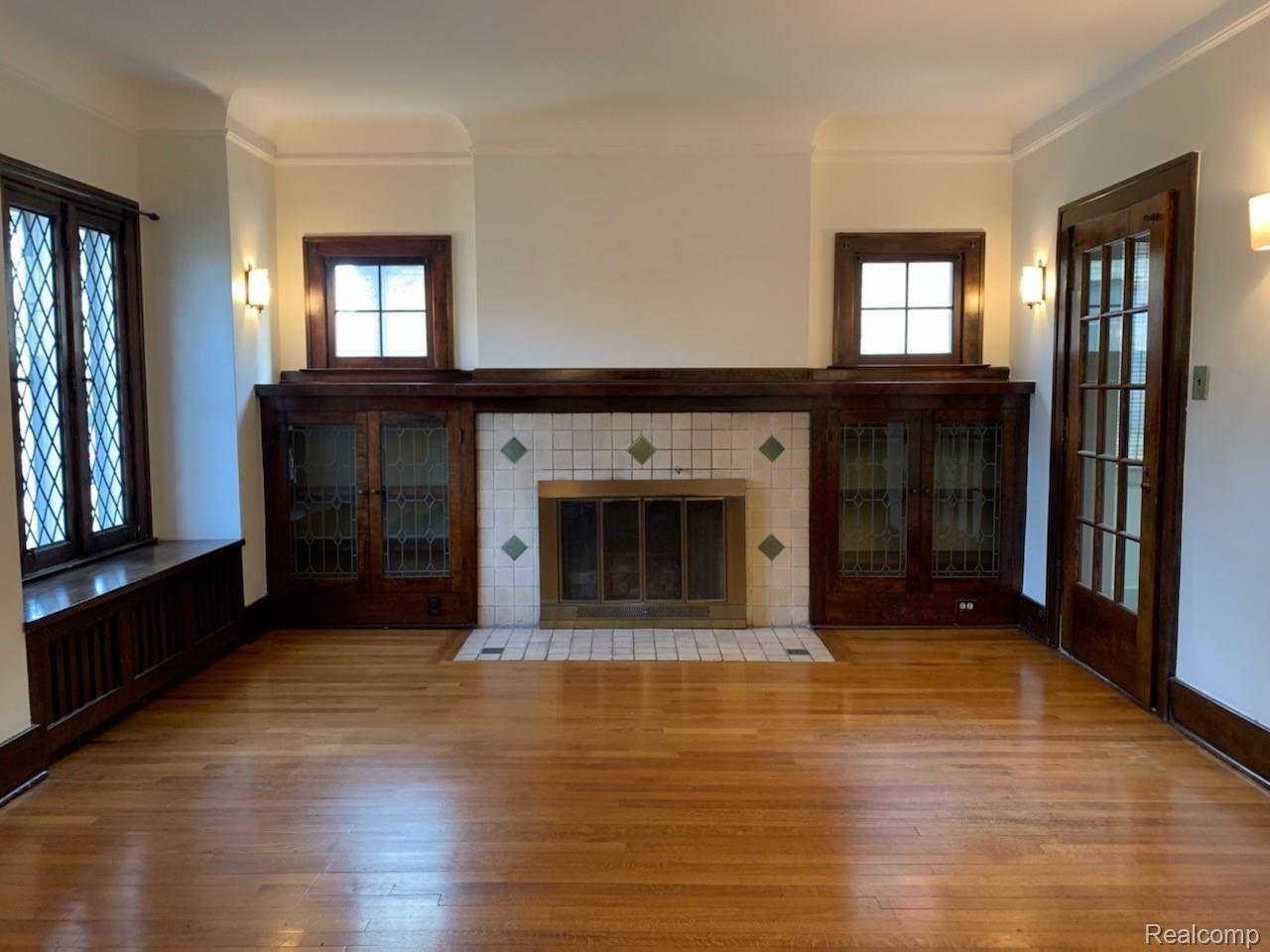 Living Room Fireplace with leaded glass bookshelves doors