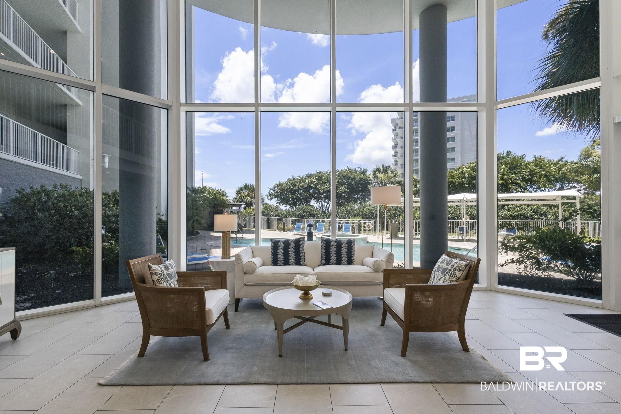 28250 Canal Road, Unit 403 Orange Beach, AL 36561 - Photo 49 of 54 Living room with a wall of windows, tile patterned floors, and a high ceiling
