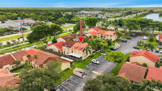 an aerial view of a city with lots of residential buildings ocean and mountain view in back