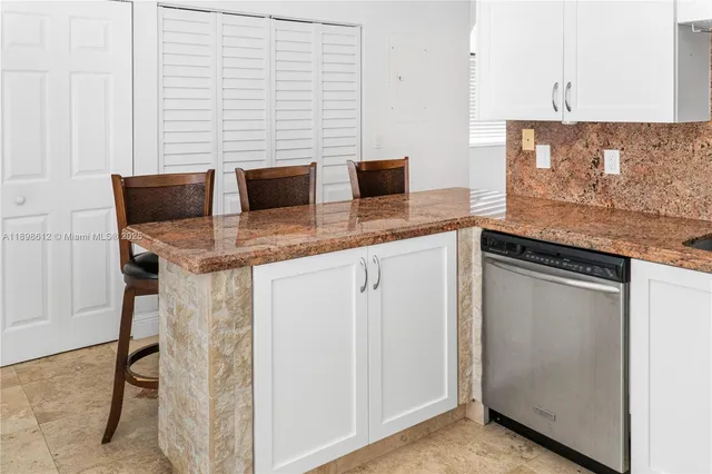 a kitchen with stainless steel appliances granite countertop a sink and a cabinets