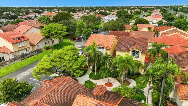 an aerial view of multiple houses with yard
