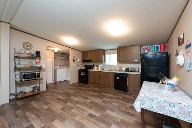 a large kitchen with a lot of counter space and refrigerator