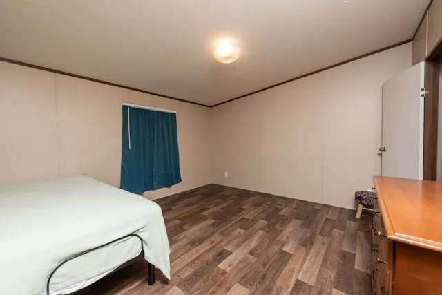 a bedroom with a bed and a dresser in it