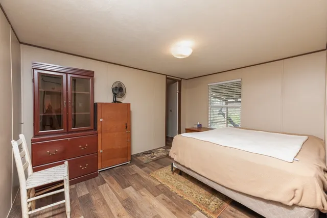 a bedroom with a bed and a dresser