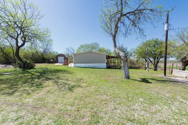 a backyard of a house with lots of green space