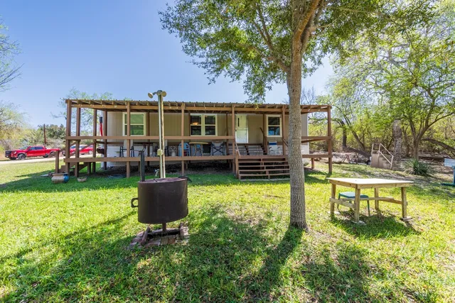 a view of a house with swimming pool and sitting area