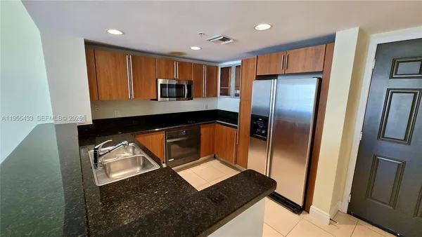 a view of a hallway with a livingroom and fireplace