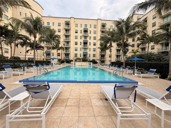 a view of swimming pool with a lounge chairs
