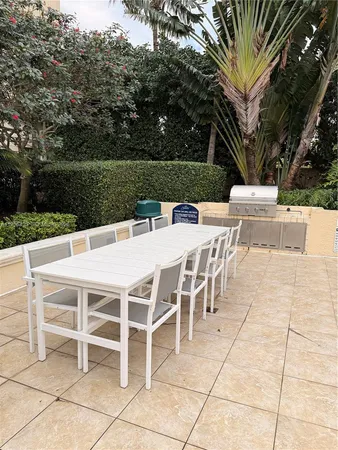 a balcony with table and chairs