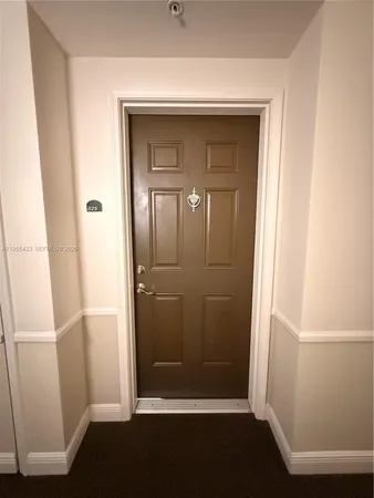 a kitchen with stainless steel appliances granite countertop a refrigerator a sink a stove with wooden cabinets