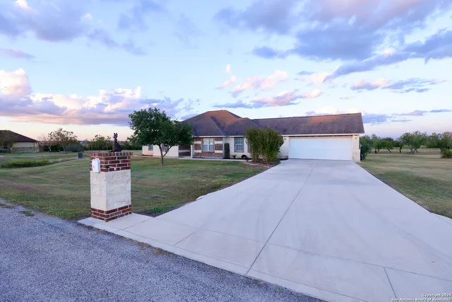 a pathway of a house with a yard