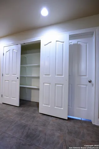 a view of an empty room with a cabinet