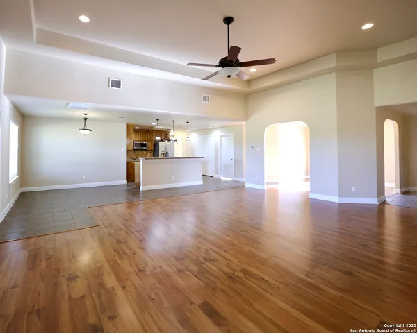 a view of a room with wooden floor and windows