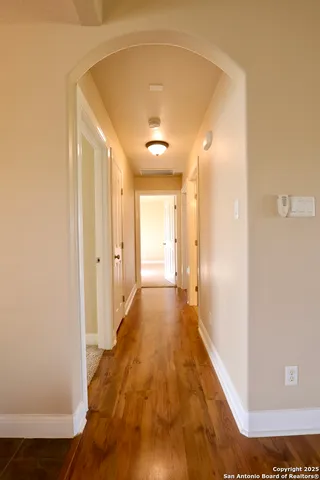 a view of a hallway with wooden floor