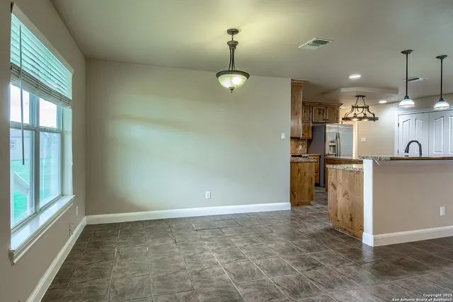 a view of a kitchen with a refrigerator cabinets and a wooden floor