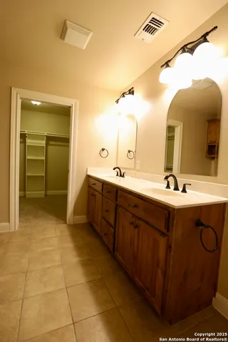 a bathroom with a sink double vanity and a mirror