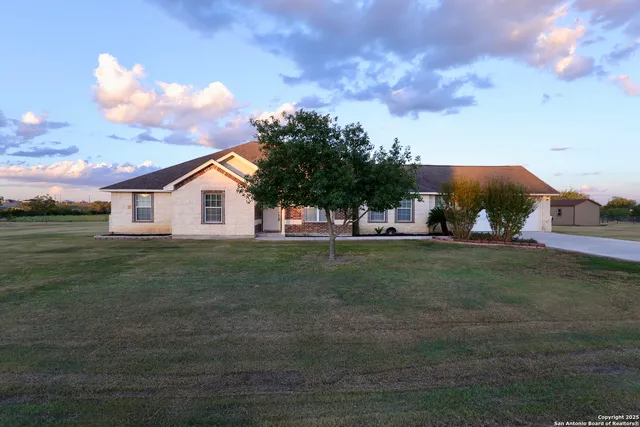 a view of a house with a backyard