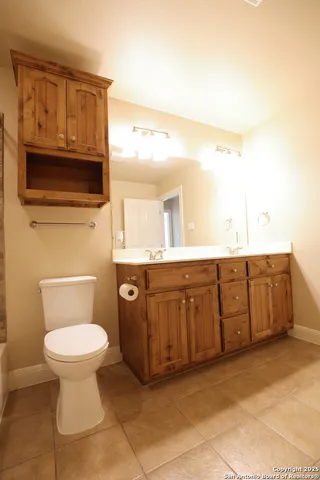 a bathroom with a sink a toilet and mirror